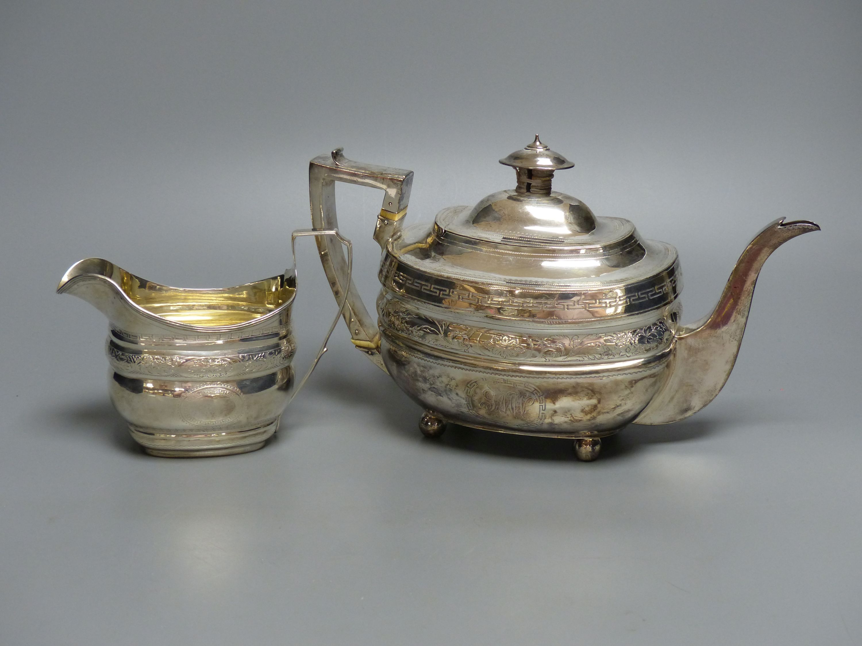 A George III silver teapot and matching cream jug, Urquhart & Hart, London, 1805/1807,